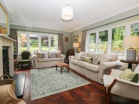 A living room with a sofa and armchair at St. Marys House, Church Westcote near Bledington