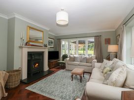 A living room with a fireplace and sofa at St. Marys House in Church Westcote near Bledington