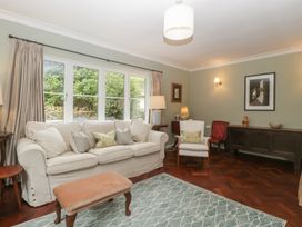 A living room with a sofa and armchair at St. Marys House Church Westcote near Bledington
