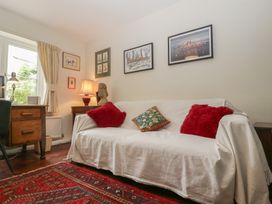 A living room with a couch and desk at St. Marys House, Church Westcote near Bledington