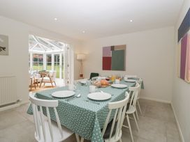 A dining room with a table set for a meal at St. Marys House Church Westcote near Bledington