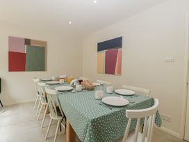 A dining room with a table set for meals at St. Marys House in Church Westcote near Bledington