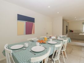 A dining room with a table set for breakfast at St. Marys House in Church Westcote near Bledington