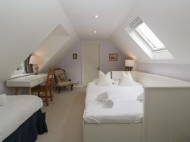A bedroom with a double bed and writing desk at St. Marys House Church Westcote near Bledington