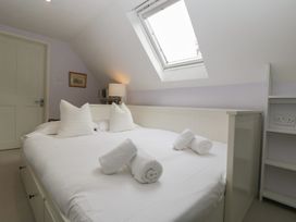 A bedroom with a bed and bookshelf at St. Marys House in Church Westcote near Bledington