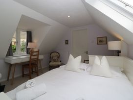A bedroom with a bed and a desk at St. Marys House in Church Westcote near Bledington