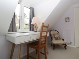 A study with a desk, chair, and lamp at St. Marys House Church Westcote near Bledington