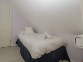 A bedroom with a bed and towels at St. Marys House Church Westcote near Bledington