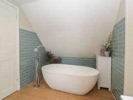 A bathroom with a bathtub and shower at St. Marys House in Church Westcote near Bledington