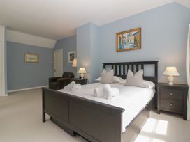 A bedroom with a bed and a chair at St. Marys House in Church Westcote near Bledington