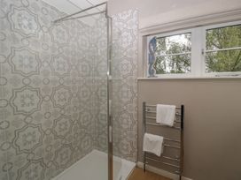 A bathroom with a shower and towel rack at St. Marys House in Church Westcote near Bledington