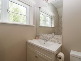 A bathroom with a washbasin and mirror at St. Marys House Church Westcote near Bledington