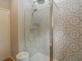 A shower enclosure with patterned tiles at St. Marys House, Church Westcote near Bledington