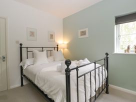 A bedroom with a bed and lamp at St. Marys House Church Westcote near Bledington