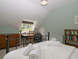A bedroom with a bed and bookshelf at St. Marys House in Church Westcote near Bledington