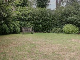 A garden with a bench surrounded by shrubs at St. Marys House Church Westcote near Bledington