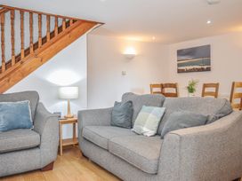 A living room with sofa and armchair at Norvys in Bossiney