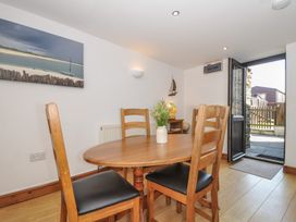 A dining room with a table and chairs at Norvys in Bossiney
