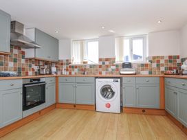 A kitchen with appliances and cabinets at Norvys in Bossiney