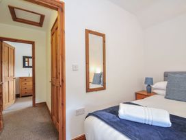A bedroom with a bed and a dresser at Norvys in Bossiney