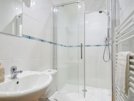 A bathroom featuring a sink, toilet, and shower at Norvys in Bossiney
