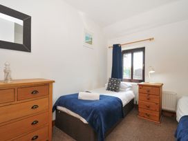 A bedroom with two beds and a window at Norvys in Bossiney