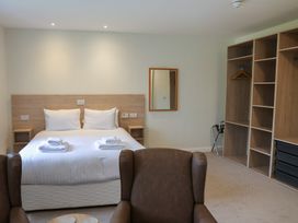 A bedroom with a bed and wardrobe at Bedroom 36 in Penrith