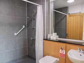 A bathroom with a shower and sink at Bedroom 36 in Penrith