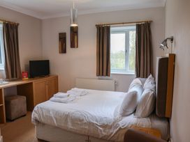 A bedroom with a bed and television at Bedroom 21 in Penrith