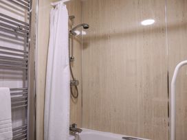 A bathroom with a bathtub and shower at Bedroom 21 in Penrith