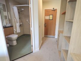 A bathroom with a toilet and shower at Eamont Park First-floor Double Bedroom in Penrith
