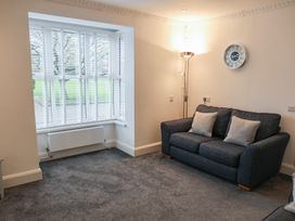 A living room with a sofa and window at Bungalow 19 Eamont Park in Penrith