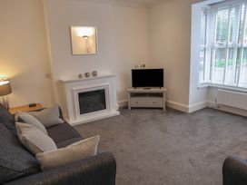 A living room with a sofa and television at Bungalow 19 Eamont Park Penrith