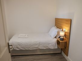 A bedroom with a single bed and bedside table at Bungalow 19 Eamont Park Penrith
