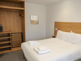 A bedroom with a bed and wardrobe at Bungalow 19 Eamont Park Penrith