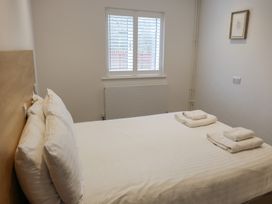 A bedroom with a bed and towels at Bungalow 19 Eamont Park Penrith