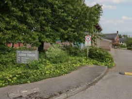 An outdoor area with a sign and building at Jubilee House in Penrith