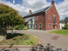 A building with trees and a pathway at Bungalow 15 Eamont Park Penrith