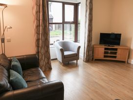 A living room with a sofa and armchair at Bungalow 14 Eamont Park Penrith