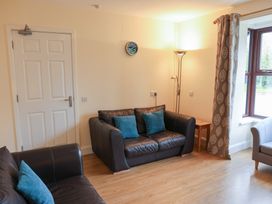 A living room with sofas and a lamp at Bungalow 14 Eamont Park in Penrith