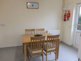 A dining room with a table and chairs at Bungalow 14 Eamont Park in Penrith