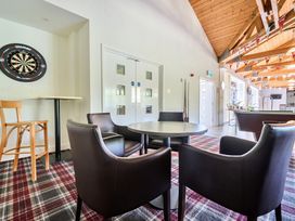 A snug with darts and seating at Jubilee Two Bedroom Accessible Bungalow Pet Friendly in Penrith