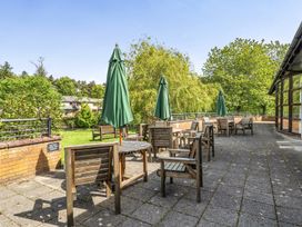 An outdoor seating area with tables and chairs at Jubilee Two Bedroom Accessible Bungalow Pet Friendly Penrith