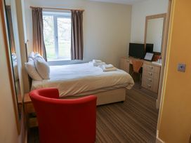 A bedroom with a bed and desk at Bedroom 7 in Penrith