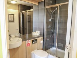 A bathroom featuring a sink, toilet, and shower at Bedroom 7 in Penrith