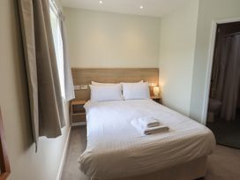 A bedroom with a bed and nightstand at Bedroom 2 in Penrith
