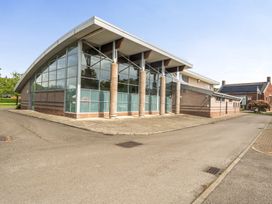 A modern building with glass windows and columns at Jubilee Two Bedroom House Pet Free Penrith