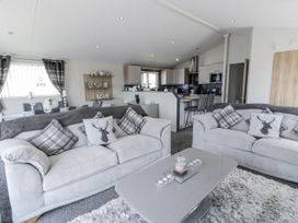 A living room with sofas and a dining area at Number 42 Wemyss Bay