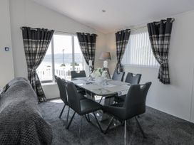 A dining room with a table and chairs at Number 42 in Wemyss Bay