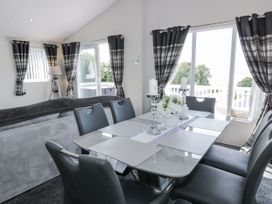 A dining area with a table and chairs at Number 42 in Wemyss Bay